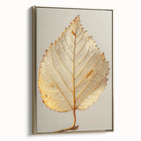 Framed canvas wall art showcasing an elegant design of flowers and botanical leaves in gold tones, displayed in a modern setting, ideal for home decor enhancement.