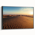 Framed canvas artwork depicting serene sand dunes in soft beige and golden hues, designed for modern interiors, showcasing a black frame from the side view.
