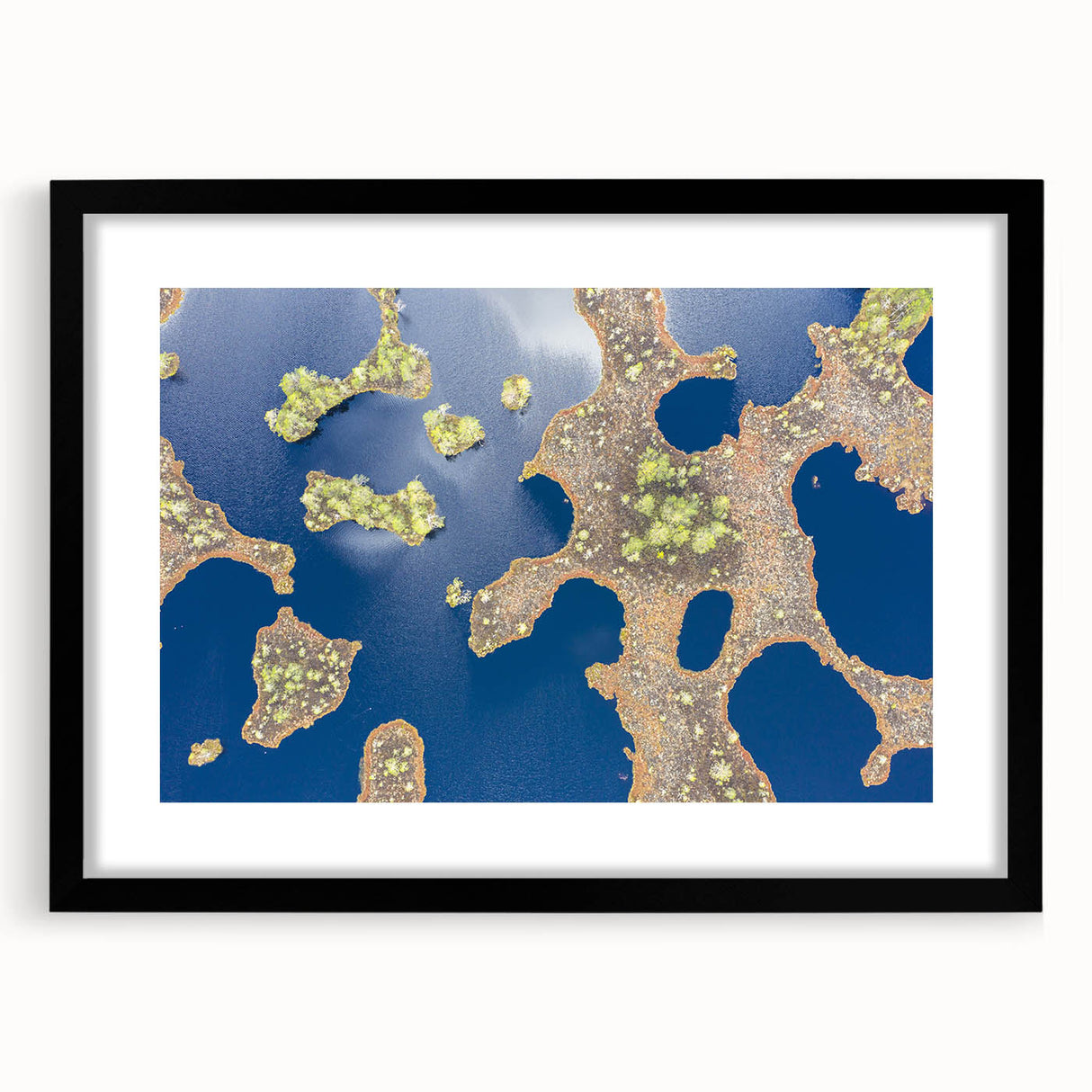 Abstract art print featuring textured, colorful art of a European scenery, in a large black frame.