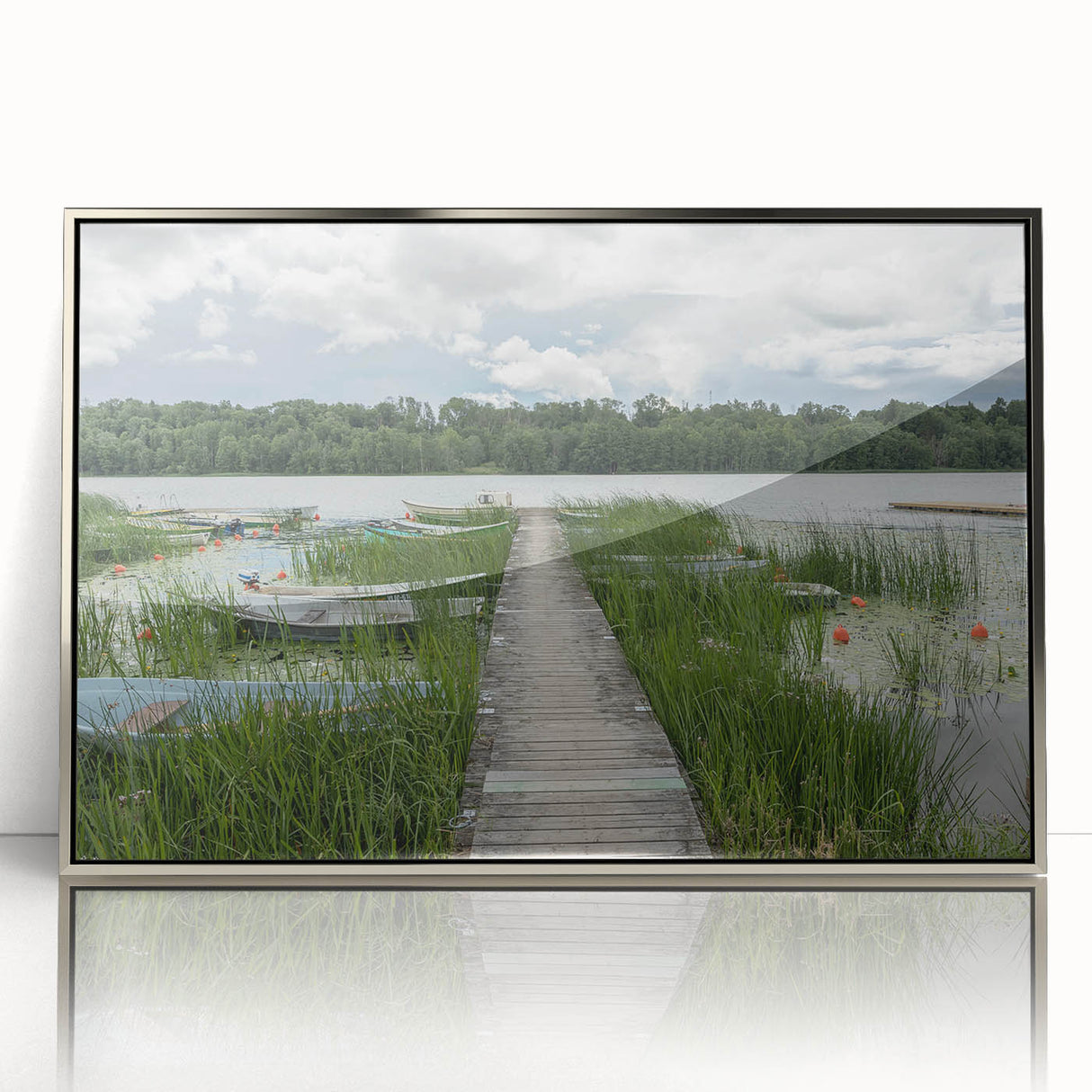 Large art print of a European Estonian scenery in muted green and blue tones on a silver-framed acrylic.