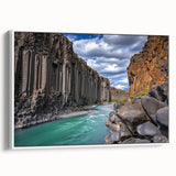 Framed canvas artwork depicting a dramatic cliff landscape in soft earth tones, showcasing textured details and a sleek white frame, ideal for modern decor.