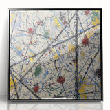 Framed acrylic artwork showcasing a modern abstract design with vibrant splatters of color on a sleek black background, perfect for contemporary home decor.
