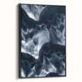 Framed canvas artwork depicting a serene landscape with caves, showcased in a sleek black frame, highlighting natural beauty and artistic detail. Ideal for modern home decor.