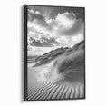 Framed canvas artwork showcasing a serene desert landscape with golden sand dunes, presented in a sleek black frame, perfect for modern decor.