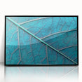 Large abstract wall art featuring close-up leaves in muted green tones on a framed acrylic.