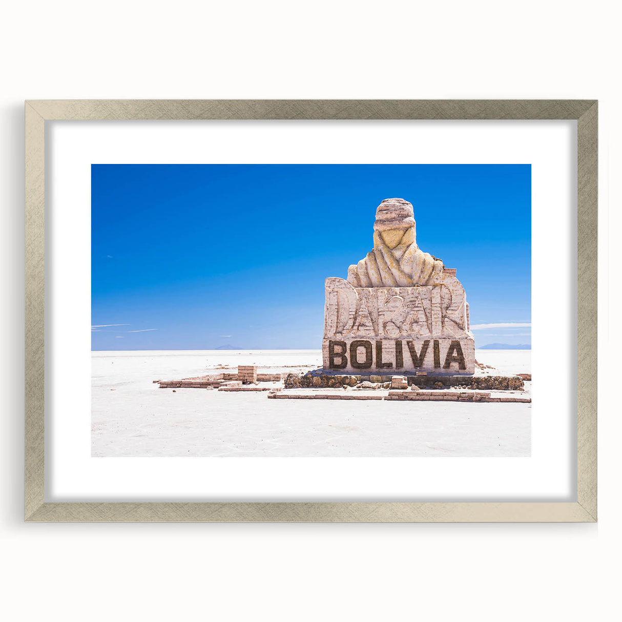 Textured abstract art print of a Bolivian landscape in muted earth tones on a framed silver mat, suitable for bedroom decor.