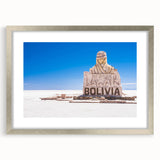 Textured abstract art print of a Bolivian landscape in muted earth tones on a framed silver mat, suitable for bedroom decor.