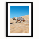 Desert landscape art framed in sleek black with a white mat, showcasing vibrant sandy tones and dramatic skies, perfect for modern home decor.