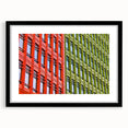 Colorful abstract art print of London scenery in vibrant hues, framed in black, suitable for living room decor.