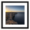Framed black landscape artwork showcasing dramatic cliffs, elegantly matted for a sophisticated display. Perfect for modern home decor, adding depth and elegance to any room.