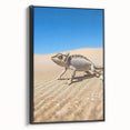 Framed canvas artwork depicting a serene desert landscape with vibrant orange and brown tones, showcasing textured details and a sleek black frame, perfect for home decor.