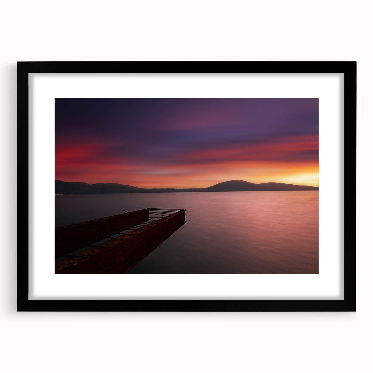 Abstract art print of a European scenery in vibrant colors on a large textured canvas, framed in black.