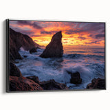 Framed canvas art depicting a dramatic landscape of cliffs in shades of blue and gray, showcasing a sleek black frame. Ideal for modern home decor.
