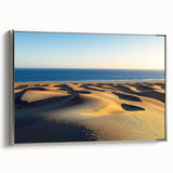 Framed canvas art showcasing a stunning desert landscape with golden dunes, featuring a sleek silver frame, ideal for modern home decor. Perfect for enhancing living spaces.