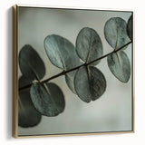 Framed canvas featuring close-up of leaves in silver and gold tones, suitable as wall art for a bedroom.