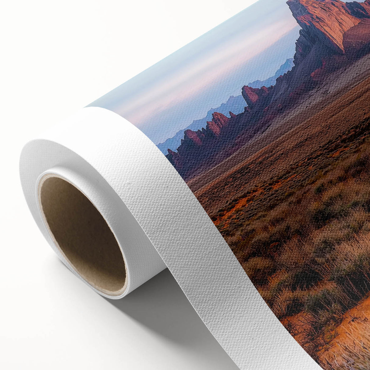 Rolled canvas showcasing a stunning desert landscape with golden dunes under a vibrant sunset, elegantly packaged in a protective cardboard tube for safe delivery.