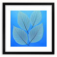 Extra large abstract art print featuring textured, colorful leaves, framed in black, ideal for living room decor.