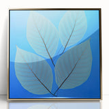 Large art print of close-up leaves in gold tones, framed in acrylic, mid-century modernist style.