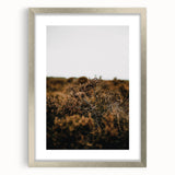 Textured abstract art print in warm autumn hues on a silver framed canvas, suitable for bedroom decor.