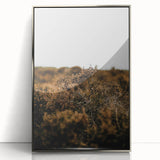 Mid-century modernist art depicting fall trees in orange and brown tones on a framed acrylic print.