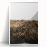 Art deco poster featuring an autumnal scene with muted orange and brown tones on a white acrylic framed print.