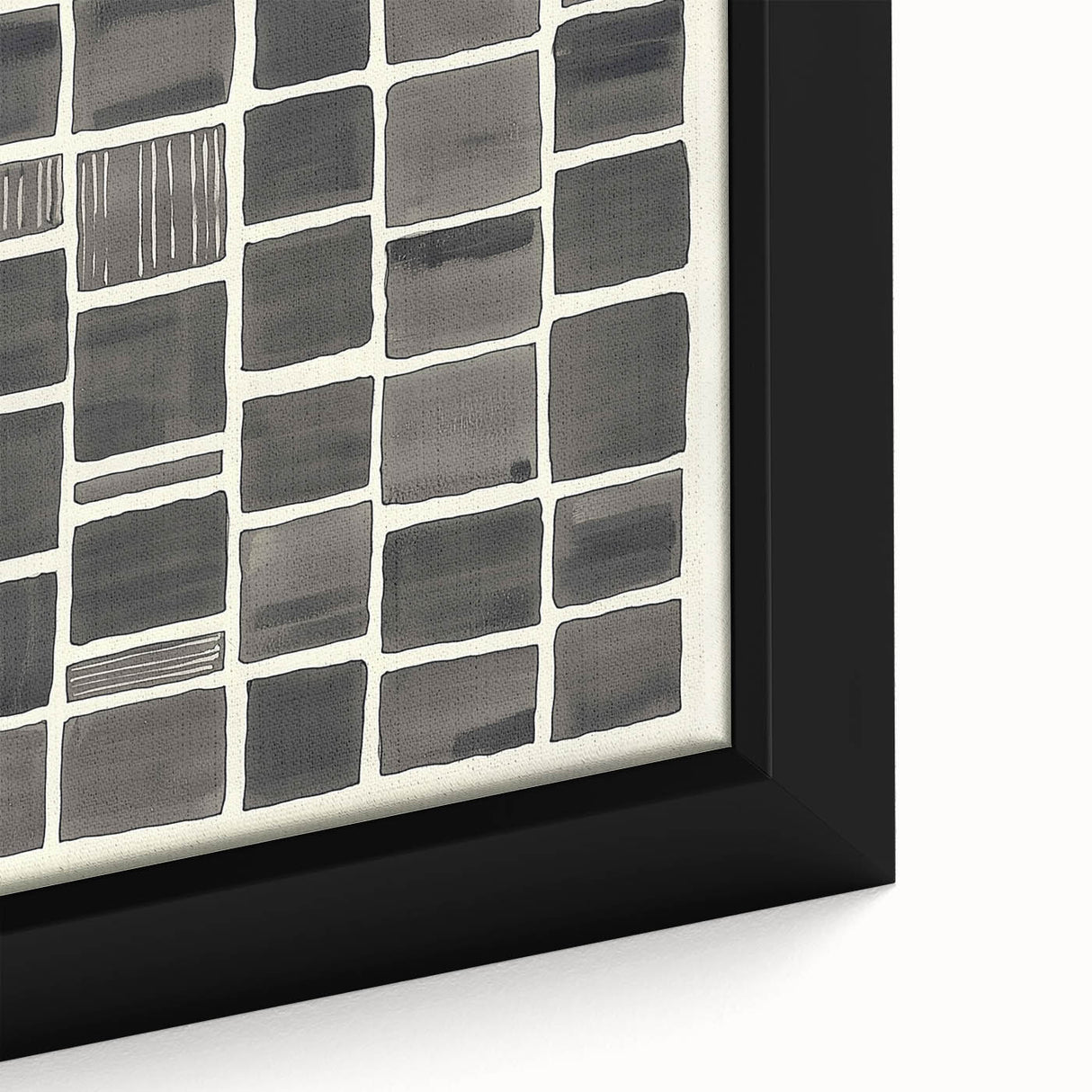 Close-up of a minimalist framed canvas artwork featuring abstract shapes in muted tones of beige and gray, showcasing its textured surface and refined details.