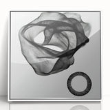 Framed abstract geometric wall art featuring dynamic shapes and a modern design in white and gray tones, perfect for contemporary home decor.
