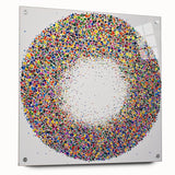 Abstract acrylic glass artwork showcasing vibrant splatters in shades of blue, pink, and yellow, mounted with decorative pins for a modern aesthetic.
