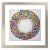 Abstract silver-framed artwork displaying vibrant splatter designs, perfect for modern decor. The mat enhances the colors, making it an eye-catching centerpiece.
