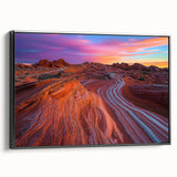 Framed canvas artwork depicting a serene desert landscape with vibrant hues of orange, yellow, and blue. The black frame adds an elegant touch, enhancing any modern decor.