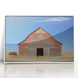 Framed acrylic artwork depicting a serene landscape scene with a barn, featuring a white frame that enhances the visual appeal. Perfect for rustic home decor.