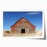 Rolled canvas print showcasing a serene landscape barn scene with vibrant colors, carefully packaged in a protective cardboard tube for safe delivery.
