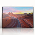Framed acrylic artwork showcasing a vibrant desert landscape with warm tones of orange and yellow, set in a sleek black frame, ideal for modern home decor.