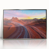 Framed acrylic artwork depicting a vibrant desert landscape, featuring warm hues of orange and yellow, elegantly displayed in a sleek silver frame, ideal for modern decor.