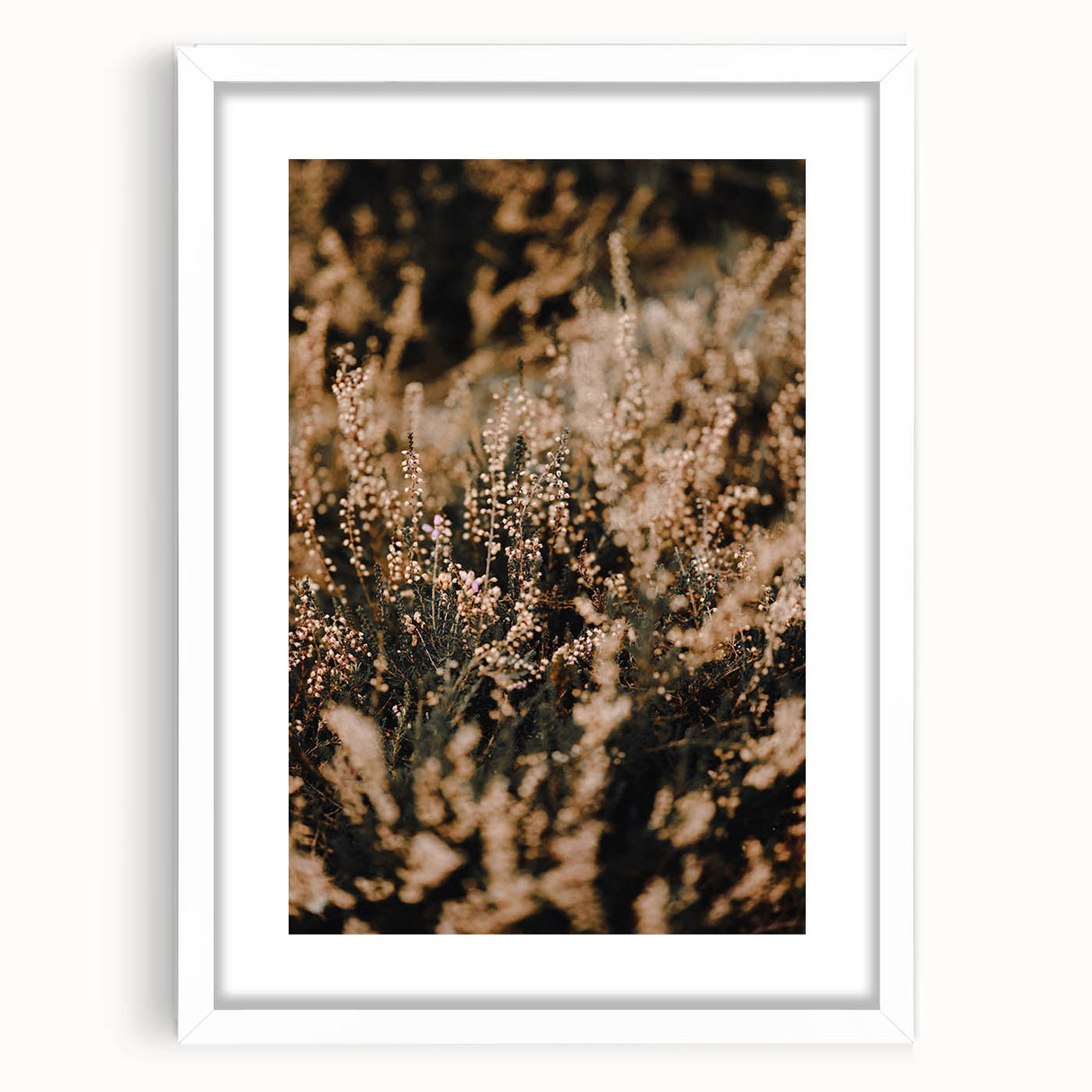 Abstract art print depicting autumnal trees in orange and red tones, framed in white.