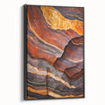 Framed canvas artwork depicting a stunning landscape of cliffs, showcasing rich colors and intricate details, with a sleek black frame enhancing its elegance.