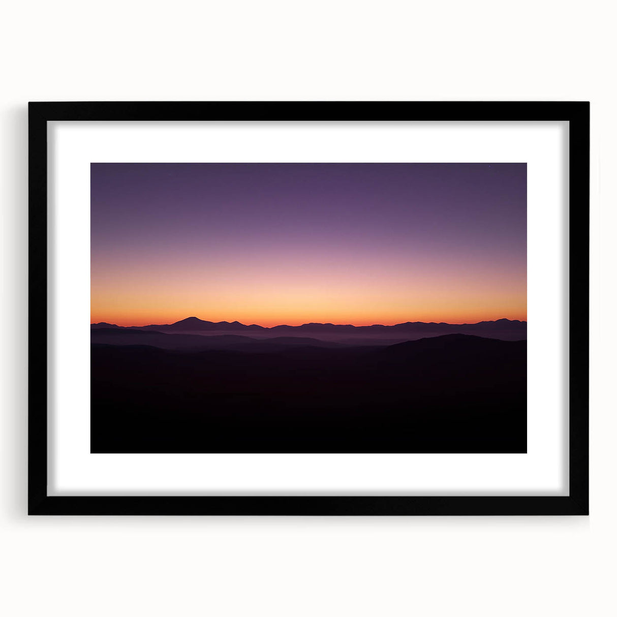 Black-framed landscape artwork depicting a desert scene, featuring warm tones of orange and beige. Ideal for modern home decor, adding a touch of nature's beauty.