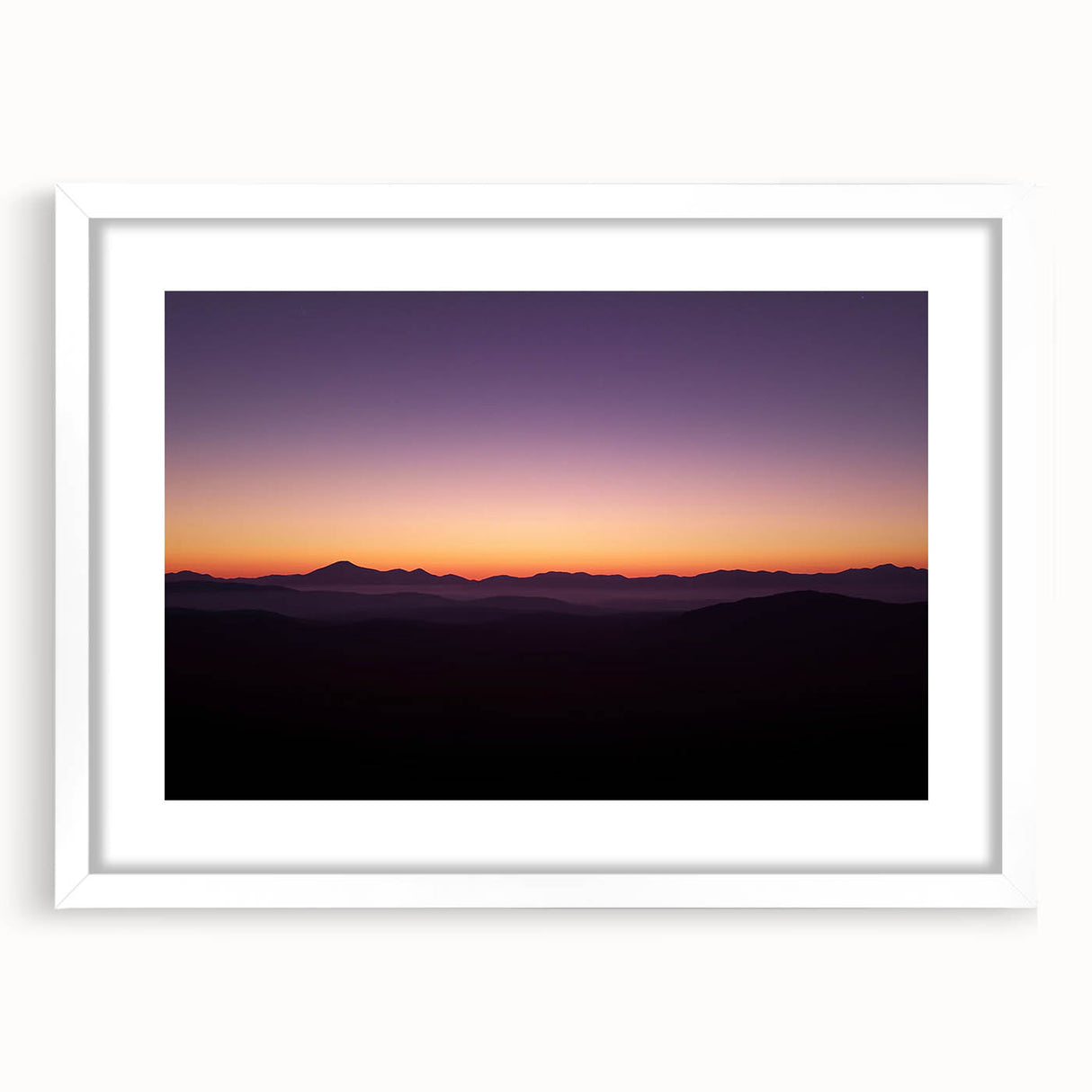 Framed desert landscape artwork with a white mat, showcasing vibrant colors and intricate details, perfect for home decor or office styling.