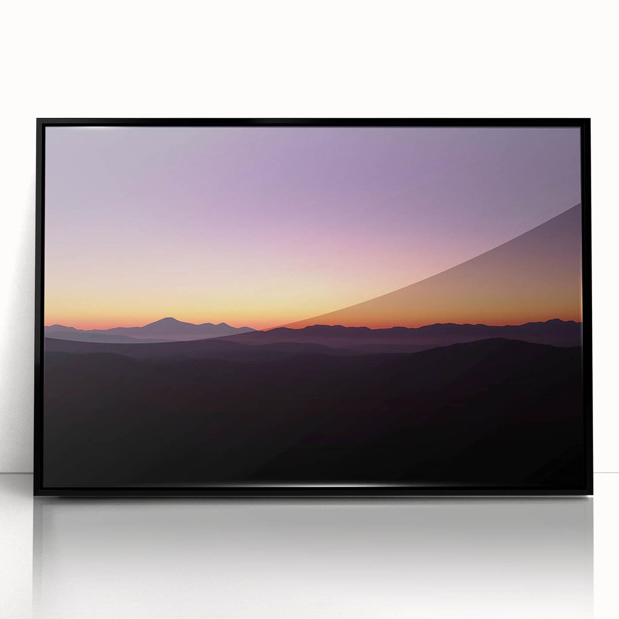 Framed acrylic artwork depicting a vibrant desert landscape with warm hues of orange and yellow, set against a sleek black frame, ideal for modern home decor.