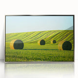 Framed acrylic artwork showcasing a serene landscape with lush green fields and a clear blue sky, elegantly designed for modern home decor.