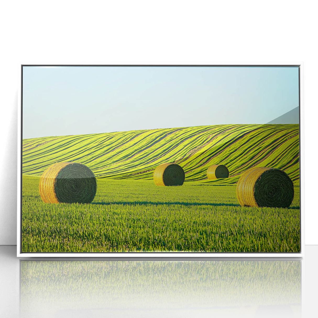 Framed acrylic artwork showcasing a vibrant landscape with rolling fields in shades of green and gold, set in a sleek white frame, ideal for home decor.