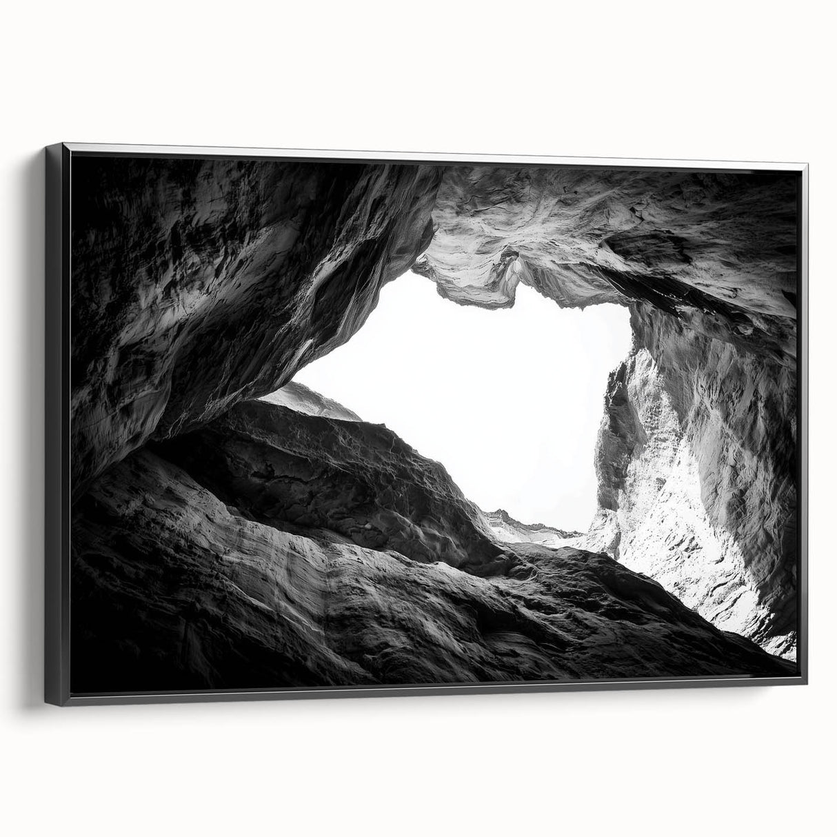 Framed canvas artwork depicting a stunning landscape of canyons in warm earth tones, set against a sleek black frame, perfect for modern home decor.