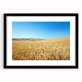 Black-framed landscape artwork showcasing a serene countryside scene, featuring vibrant greens and blues, ideal for home decor or office ambiance.