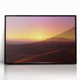 Framed acrylic artwork depicting a vibrant desert landscape with warm tones of orange and yellow, set in a sleek black frame, ideal for modern decor.