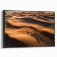 Framed canvas artwork depicting serene sand dunes at sunset, showcasing warm beige and gold tones, perfect for enhancing modern home decor.