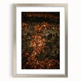 Textured abstract art print in warm autumn hues on a silver-framed canvas, ideal for bedroom wall decor.
