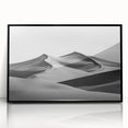 Framed acrylic artwork showcasing a serene desert landscape with golden sand dunes, featuring a sleek black frame, ideal for modern home decor.