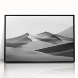 Framed acrylic artwork showcasing a serene desert landscape with golden sand dunes, featuring a sleek black frame, ideal for modern home decor.