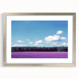 Elegant silver-framed landscape artwork with a mat, showcasing vibrant green fields under a bright blue sky, ideal for modern home decor.