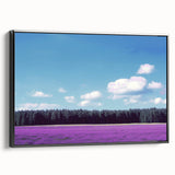 Framed canvas artwork depicting a serene landscape of rolling fields under a vibrant blue sky, showcasing a sleek black frame that enhances the natural colors and textures. Ideal for home decor, this piece adds a touch of tranquility to any space.